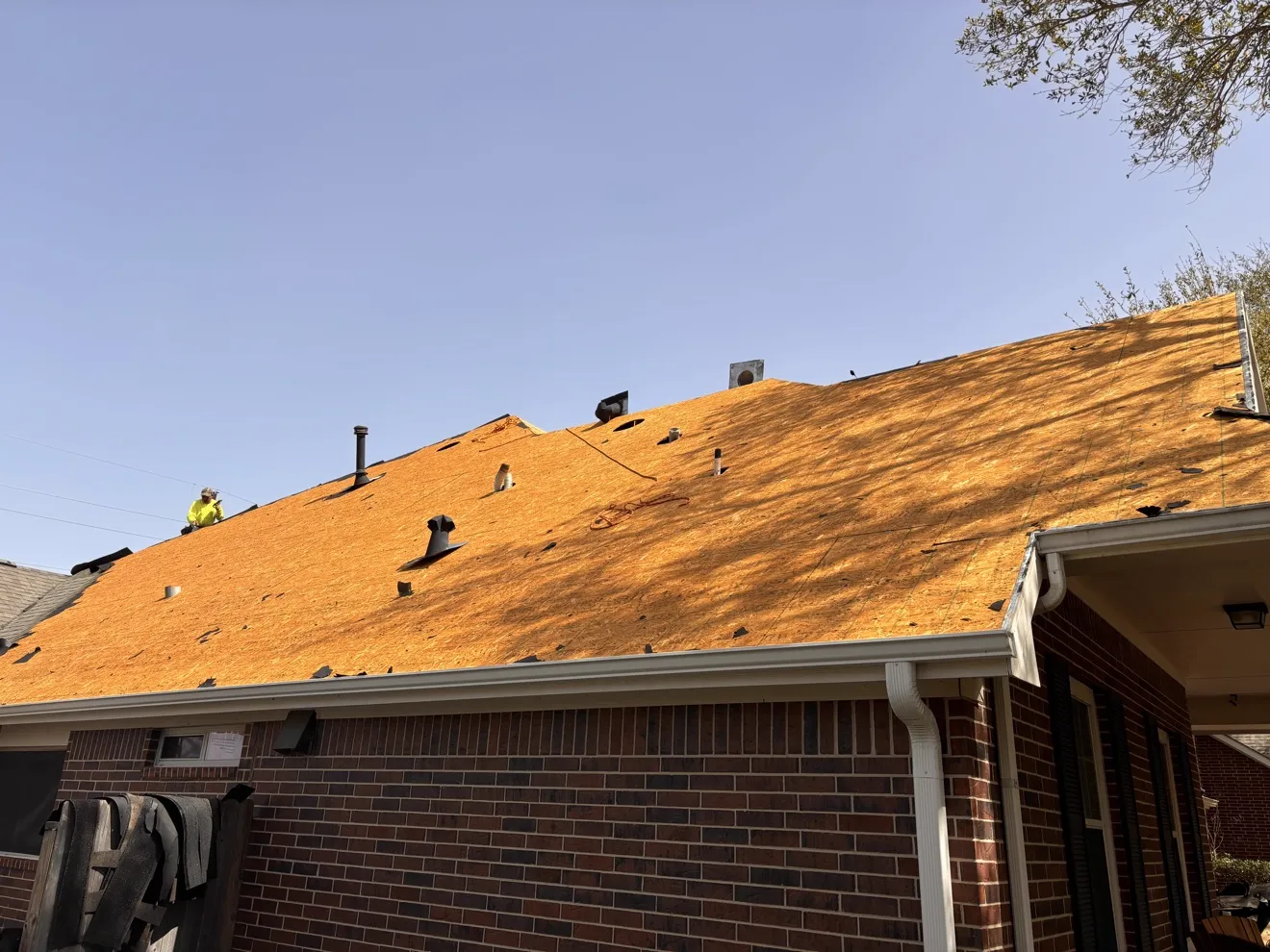 Full roof tear-off exposing a clean wooden deck