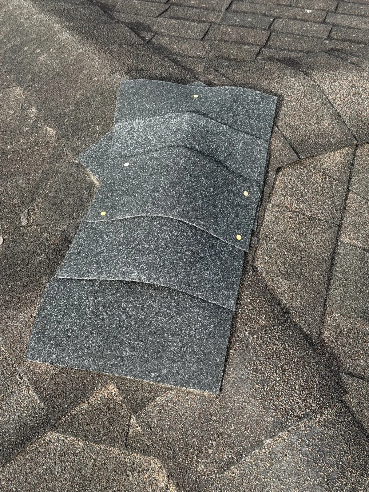 Newly installed architectural shingles after roof repair