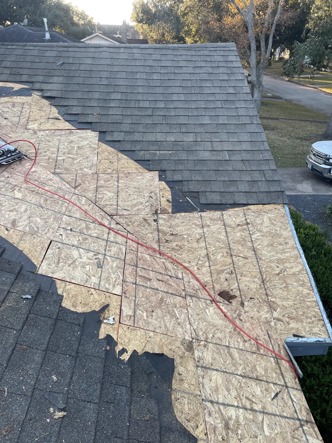 New architectural shingles being installed over new OSB decking