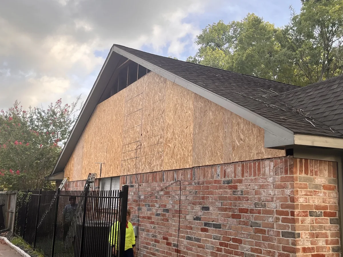 Gable end sheathing exposed during siding repair, substrate checked before new boards